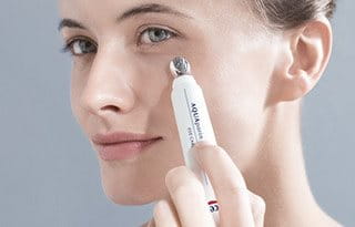 Woman applying eye care