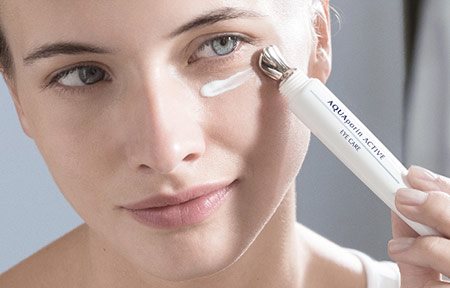 Woman applying eye care